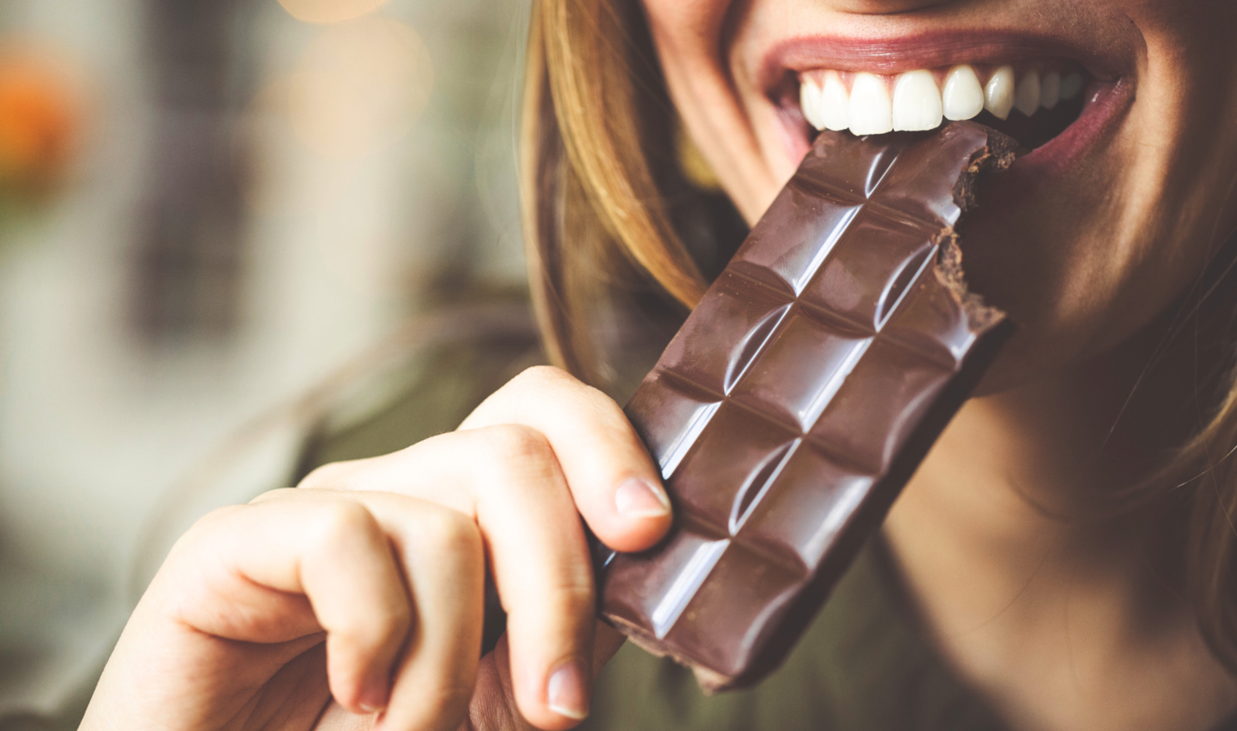 woman eating chocolate bar